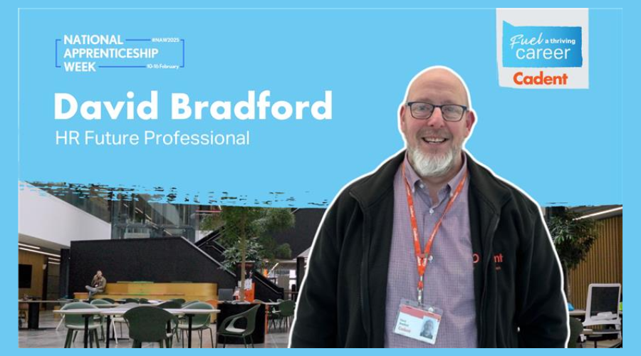 Image of David Bradford, an HR Future Professional apprentice at Cadent, smiling in a modern office setting with a National Apprenticeship Week banner and Cadent branding displayed.