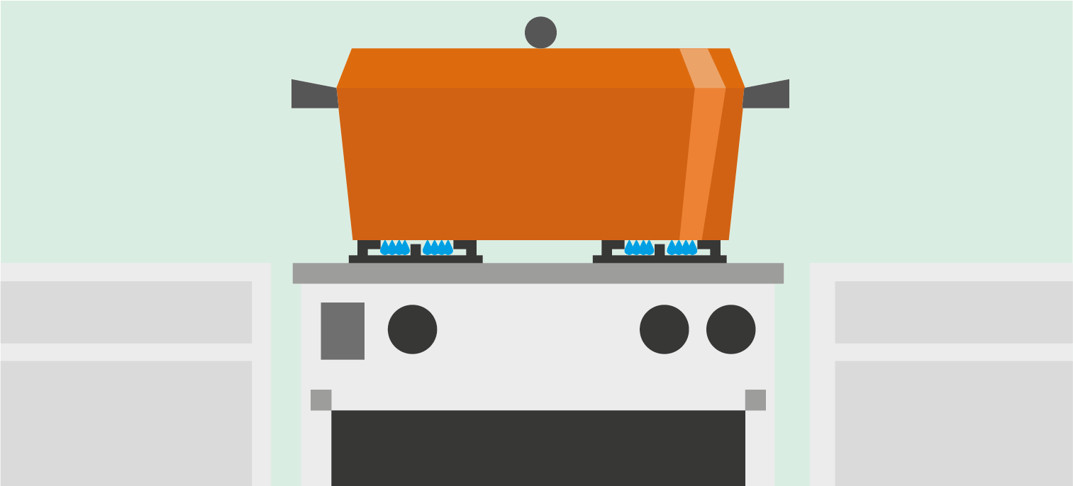 Orange cooking pot on a gas stove with two blue flames