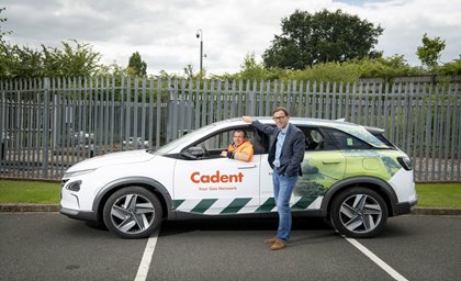 A man stands beside a white SUV with 