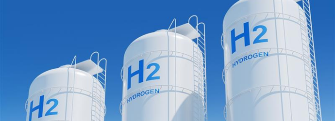Large storage tanks with H2 and HYDROGEN labels on a blue sky background