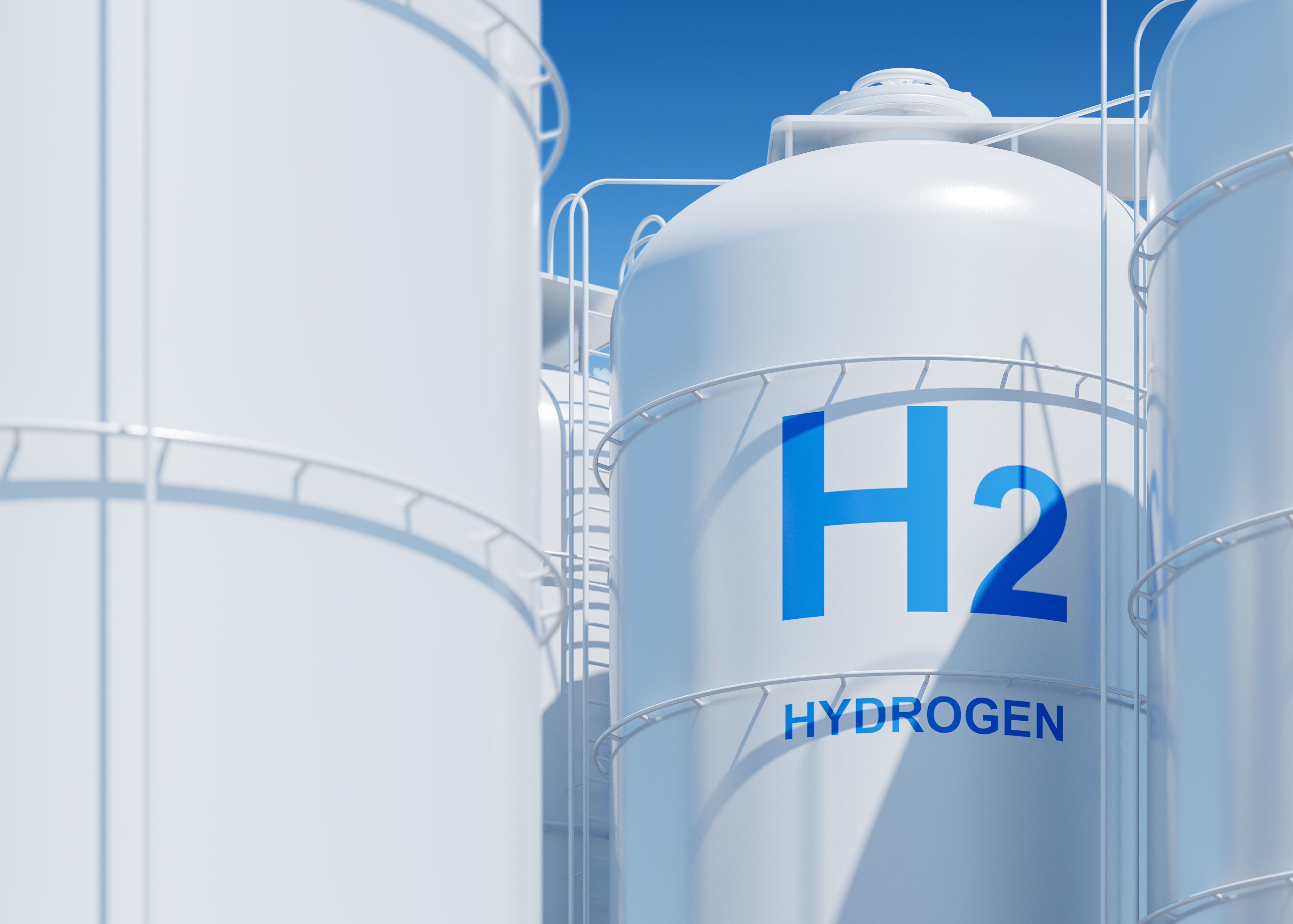 Large industrial hydrogen storage tanks against a blue sky, concept of clean energy solutions.