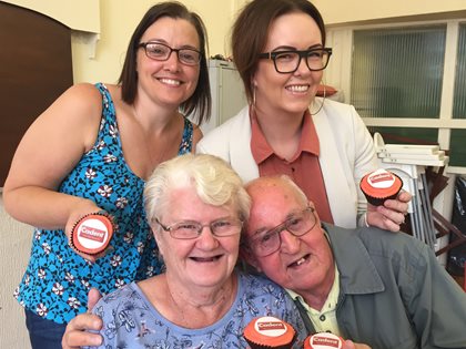 Family of four holding the Cadent Cup Cakes in their hand.